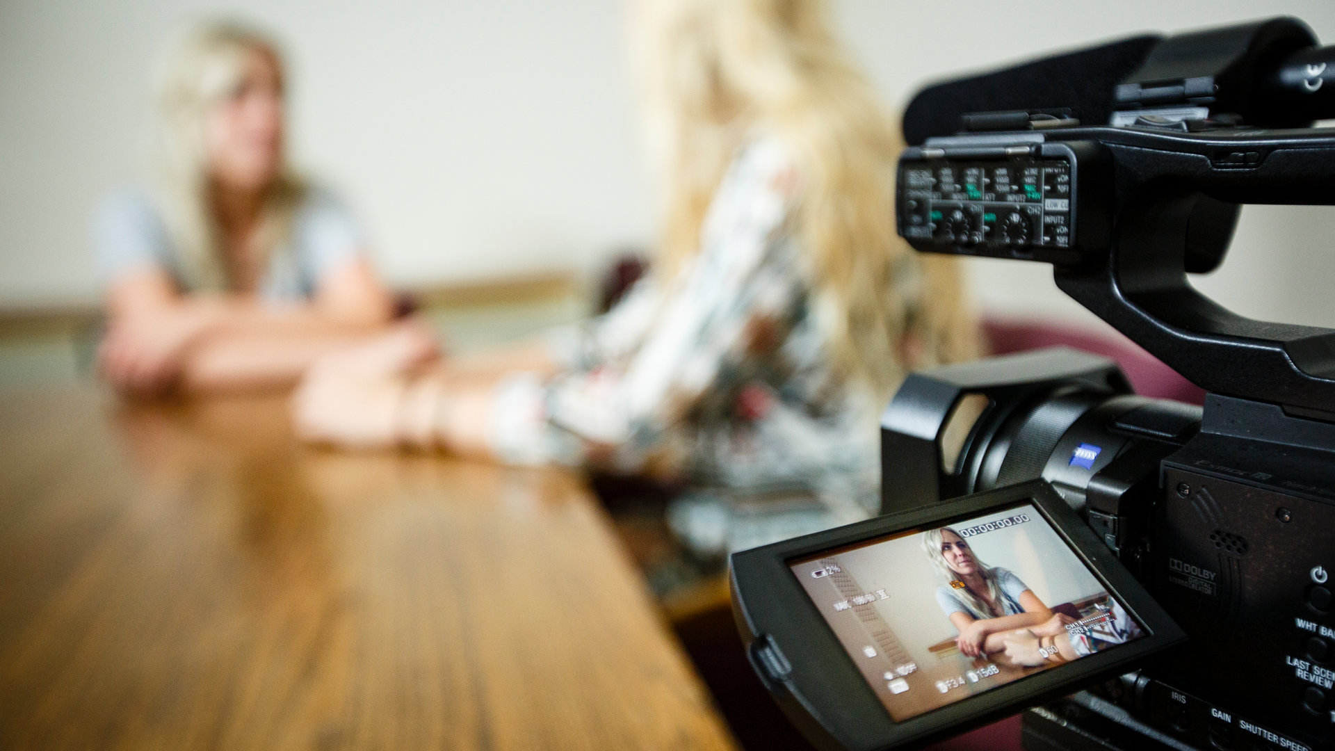 Two women film a video.